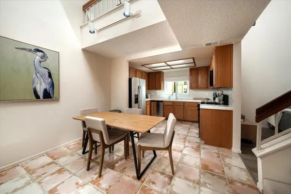 a view of a dining room with furniture and a kitchen