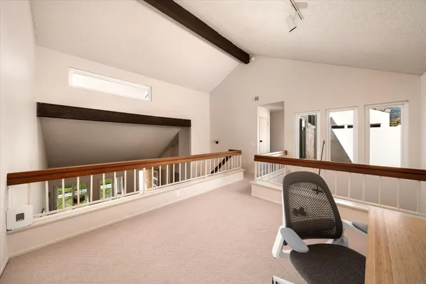 a view of a hallway with seating area
