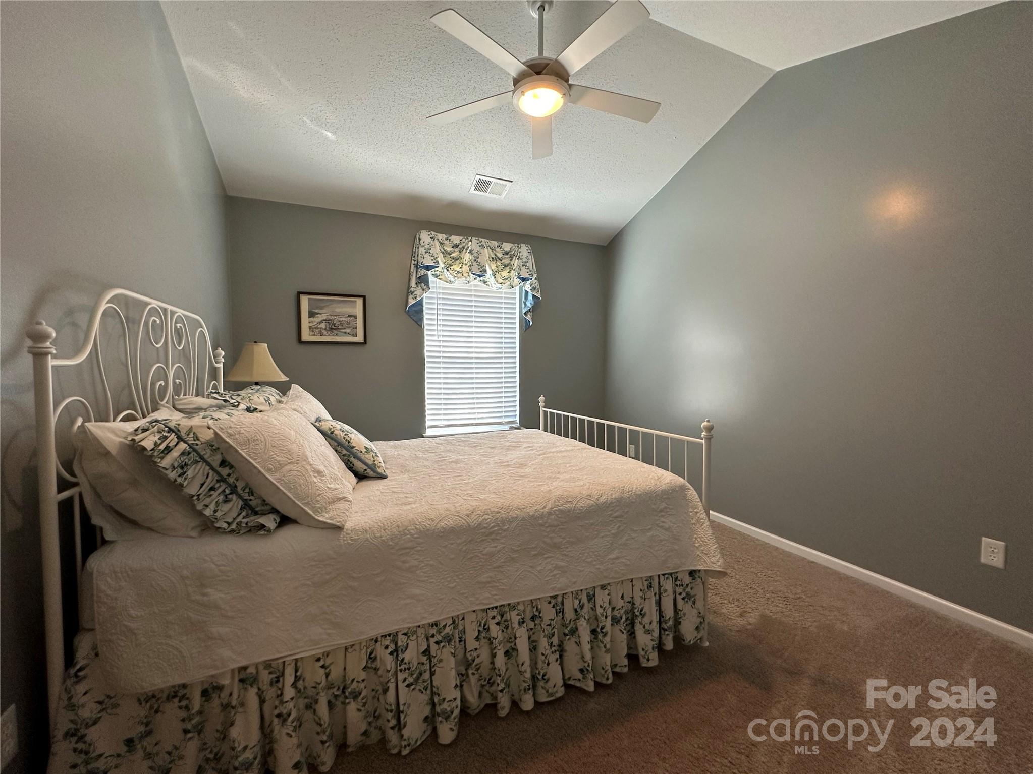 11330 Stone Trail Road Charlotte, NC 28213 - Photo 17 of 24 a bedroom with a bed and a chandelier