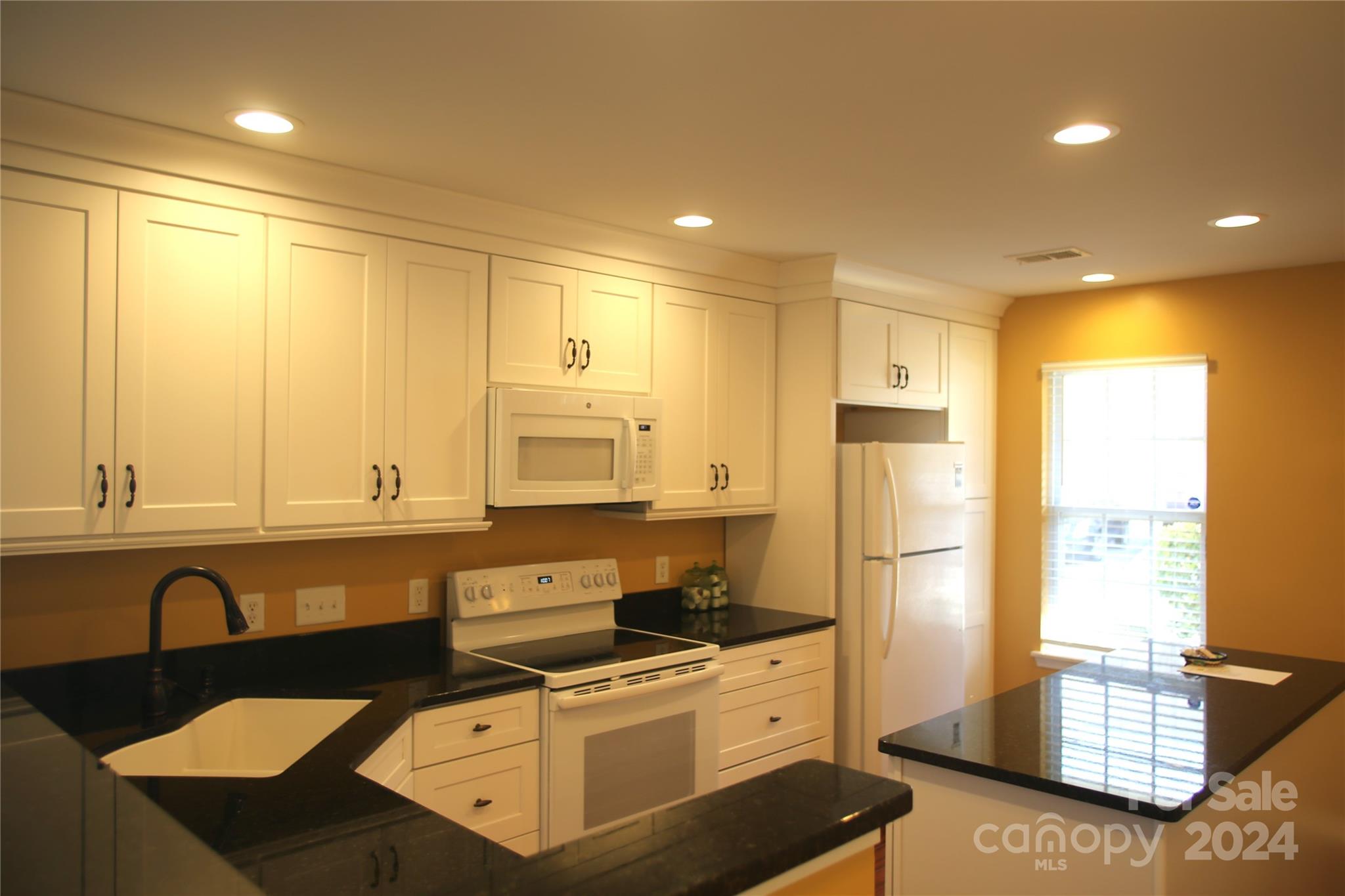 11330 Stone Trail Road Charlotte, NC 28213 - Photo 8 of 24 a kitchen with stainless steel appliances granite countertop a stove a sink and a refrigerator