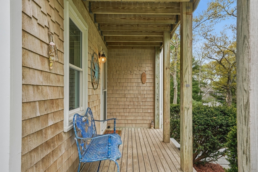 55 Ridgeview Drive Falmouth, MA 02540 - Photo 11 of 32 a view of a wooden door and chair in the patio