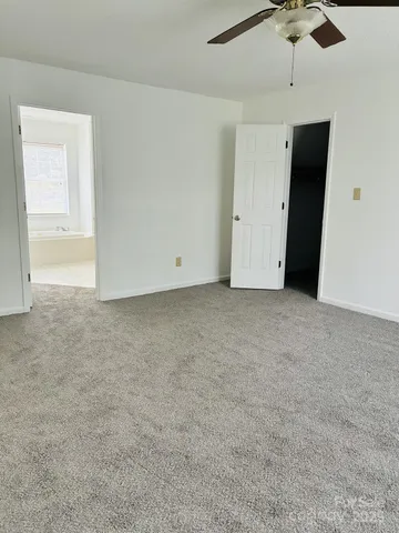 a view of an empty room with a ceiling fan
