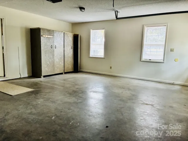 an empty room with windows and closet
