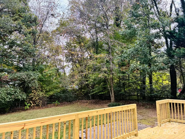 a view of deck with chairs and wooden fence