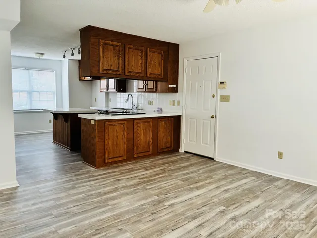 a view of kitchen with wooden floor and electronic appliances