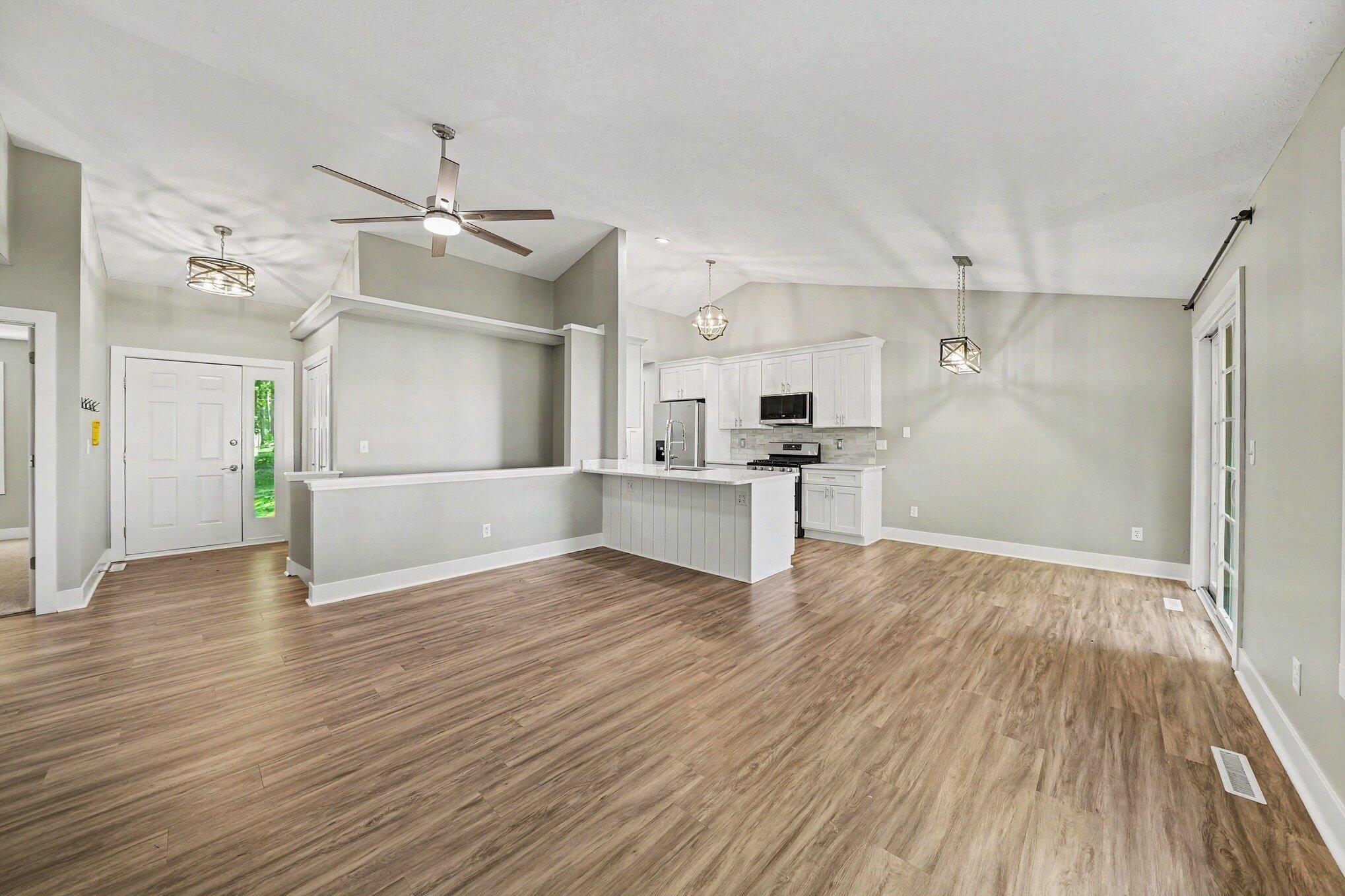 7563 East 400 North Rolling Prairie, IN 46371 - Photo 3 of 17 a view of a kitchen with wooden floor and a kitchen
