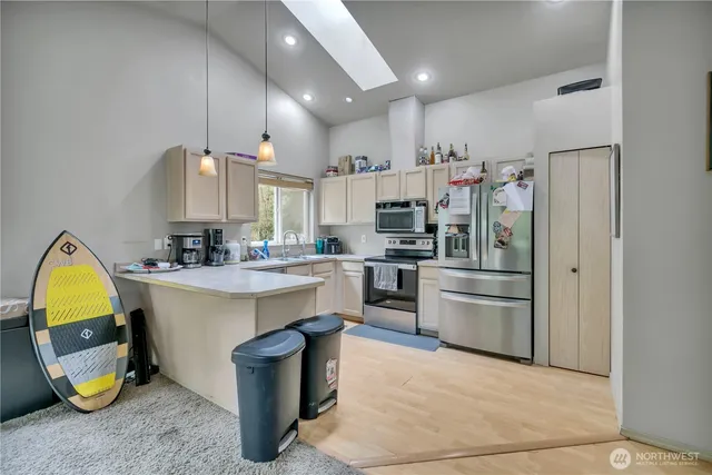 a kitchen with a sink appliances and cabinets
