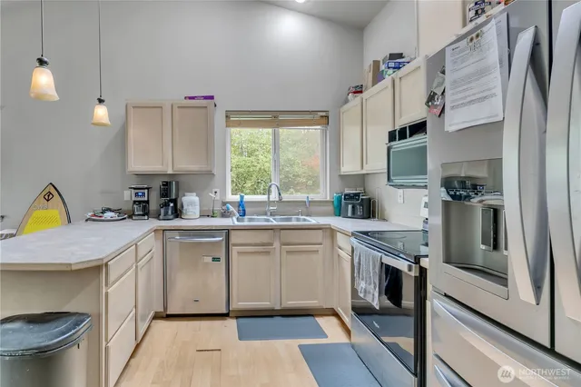 a kitchen with a sink stove and cabinets