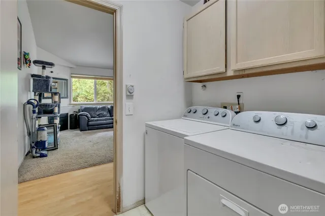 a utility room with faucet washer and dryer