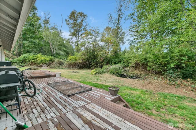 a view of backyard with seating area and green space