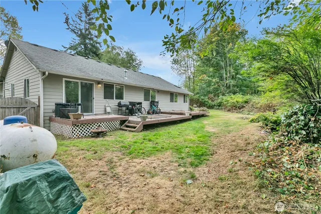 an aerial view of residential house with outdoor space and trees around