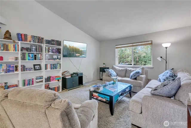 a living room with furniture and a book shelf