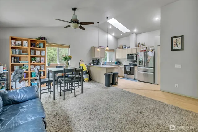a living room with stainless steel appliances kitchen island granite countertop furniture and a kitchen view