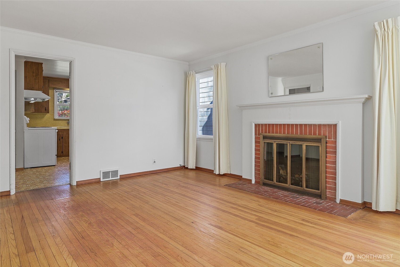 4437 47th Avenue Southwest Seattle, WA 98116 - Photo 11 of 39 a view of an empty room with glass door and wooden floor