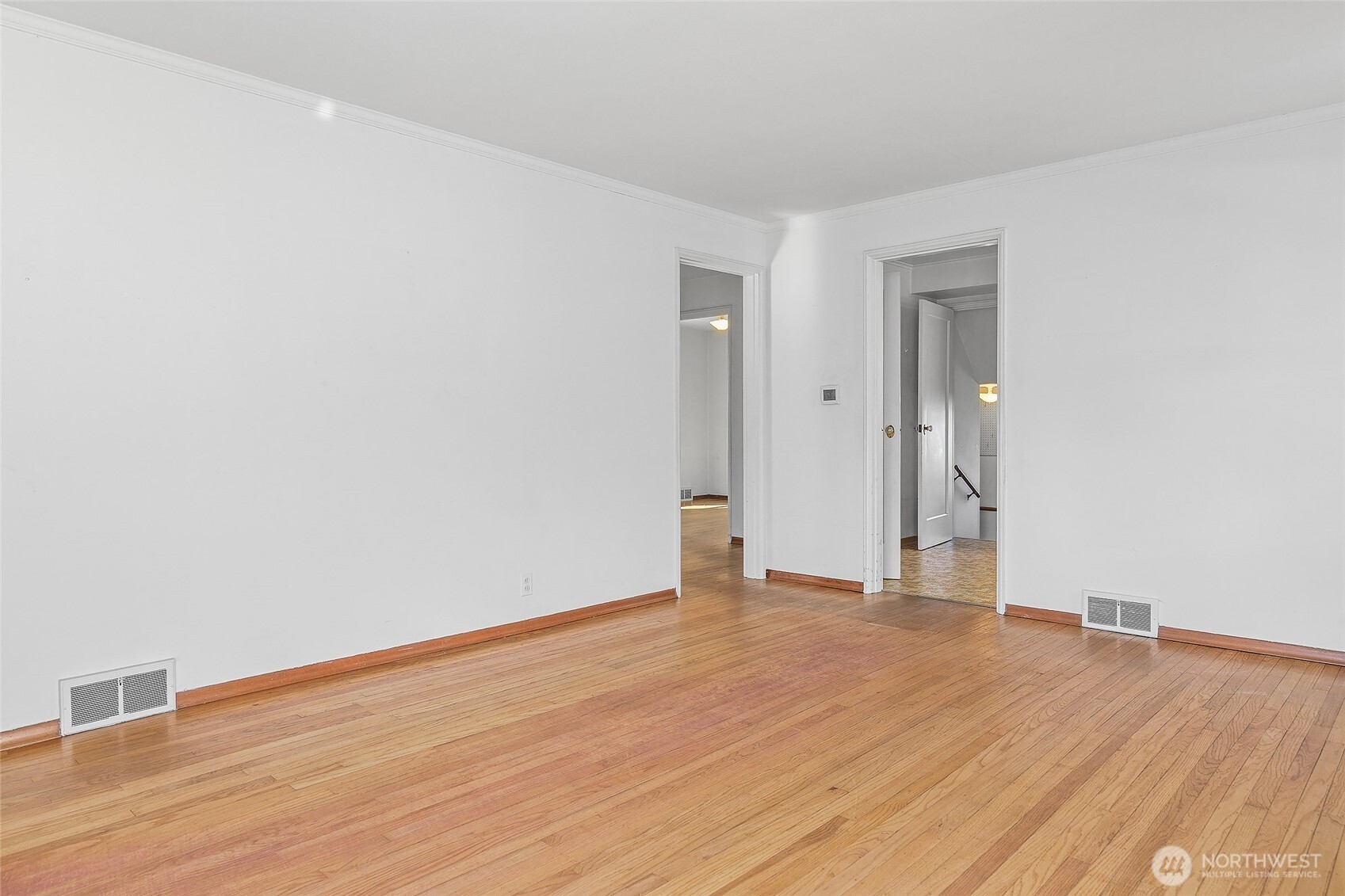 4437 47th Avenue Southwest Seattle, WA 98116 - Photo 13 of 39 a view of an empty room with wooden floor