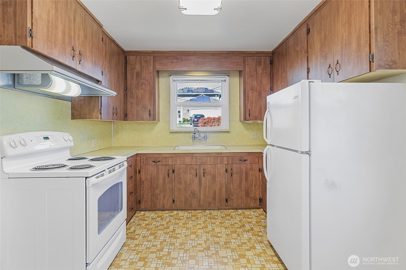 4437 47th Avenue Southwest Seattle, WA 98116 - Photo 14 of 39 a kitchen with a refrigerator sink and cabinets