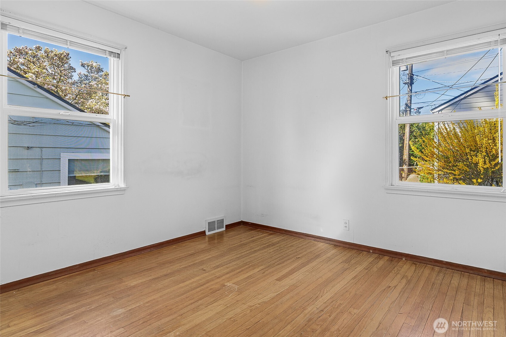 4437 47th Avenue Southwest Seattle, WA 98116 - Photo 20 of 39 a view of an empty room with wooden floor and a window
