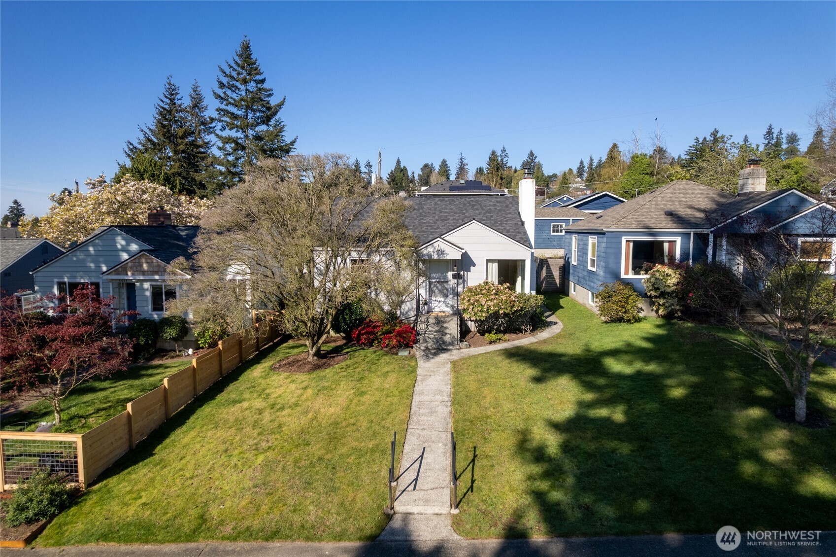 4437 47th Avenue Southwest Seattle, WA 98116 - Photo 2 of 39 a front view of a house with a yard