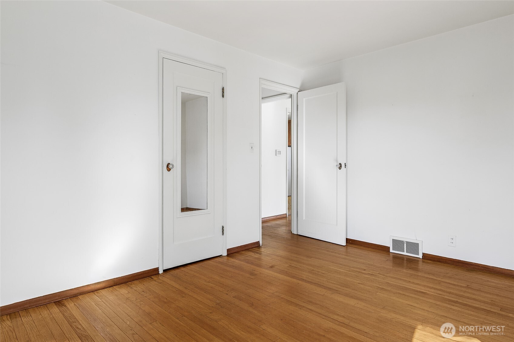 4437 47th Avenue Southwest Seattle, WA 98116 - Photo 25 of 39 a view of empty room with wooden floor
