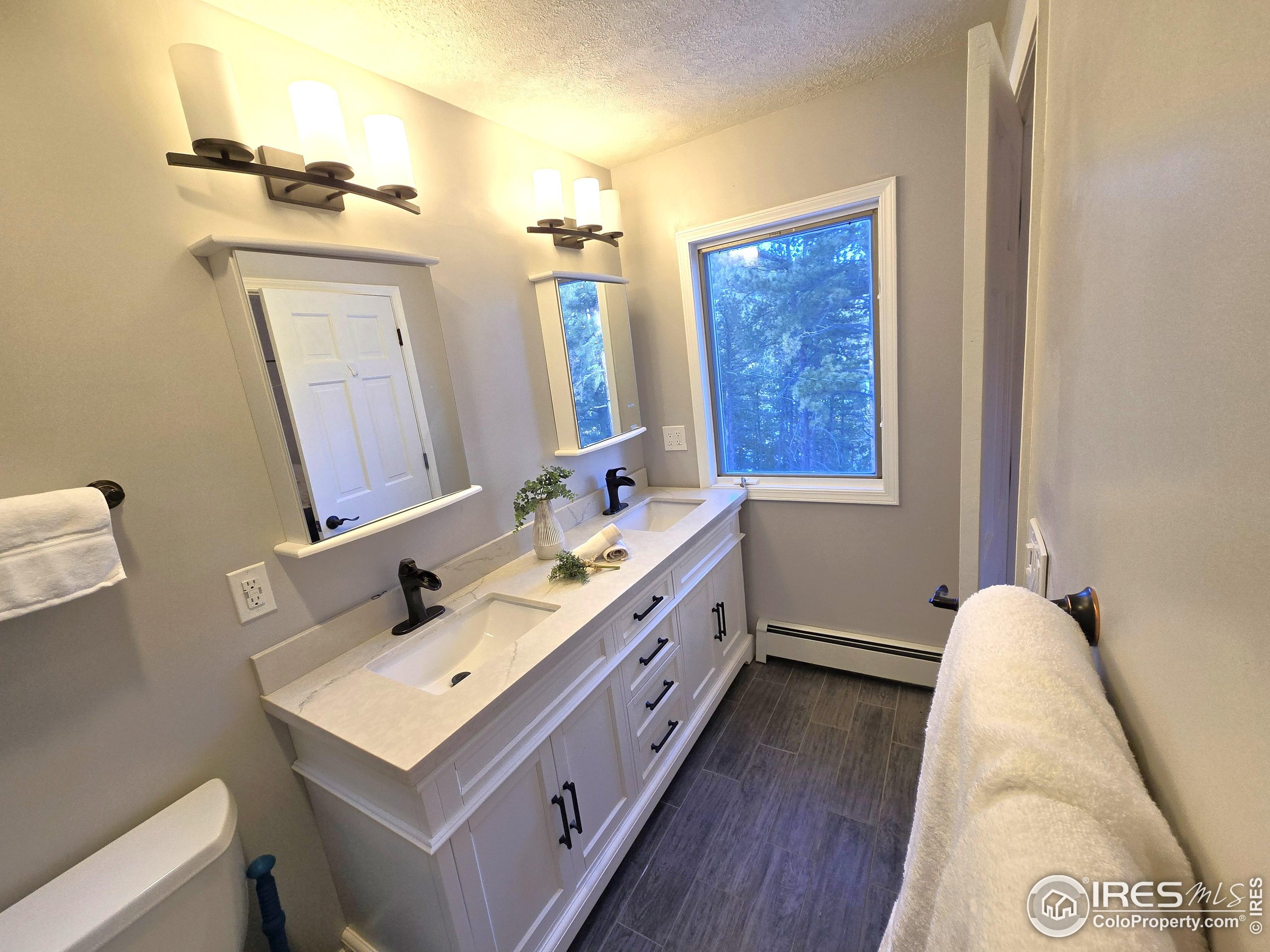 76 Pine Tree Lane Boulder, CO 80304 - Photo 16 of 49 a bathroom with a double vanity sink mirror and