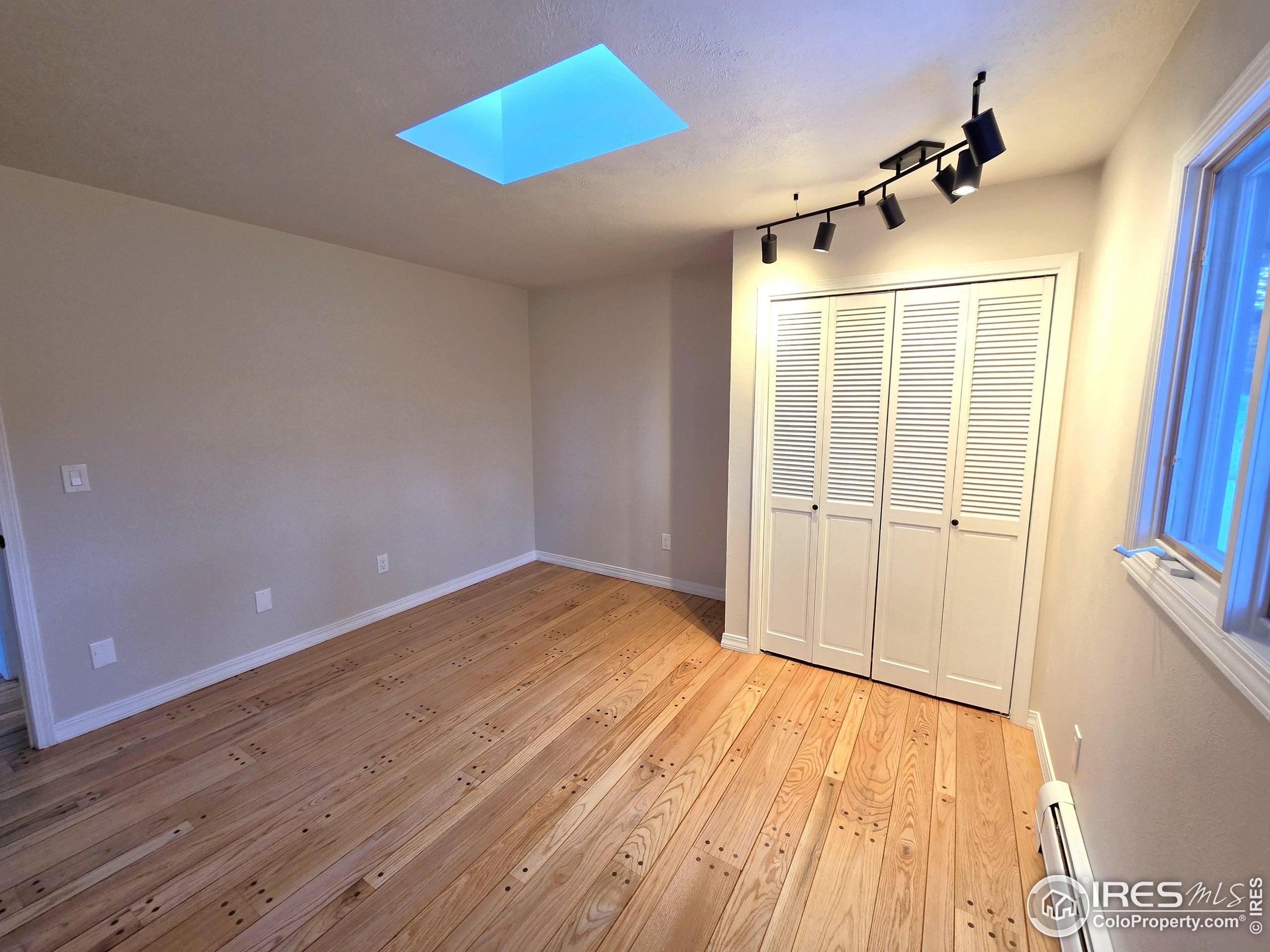 76 Pine Tree Lane Boulder, CO 80304 - Photo 20 of 49 wooden floor in an empty room with a window