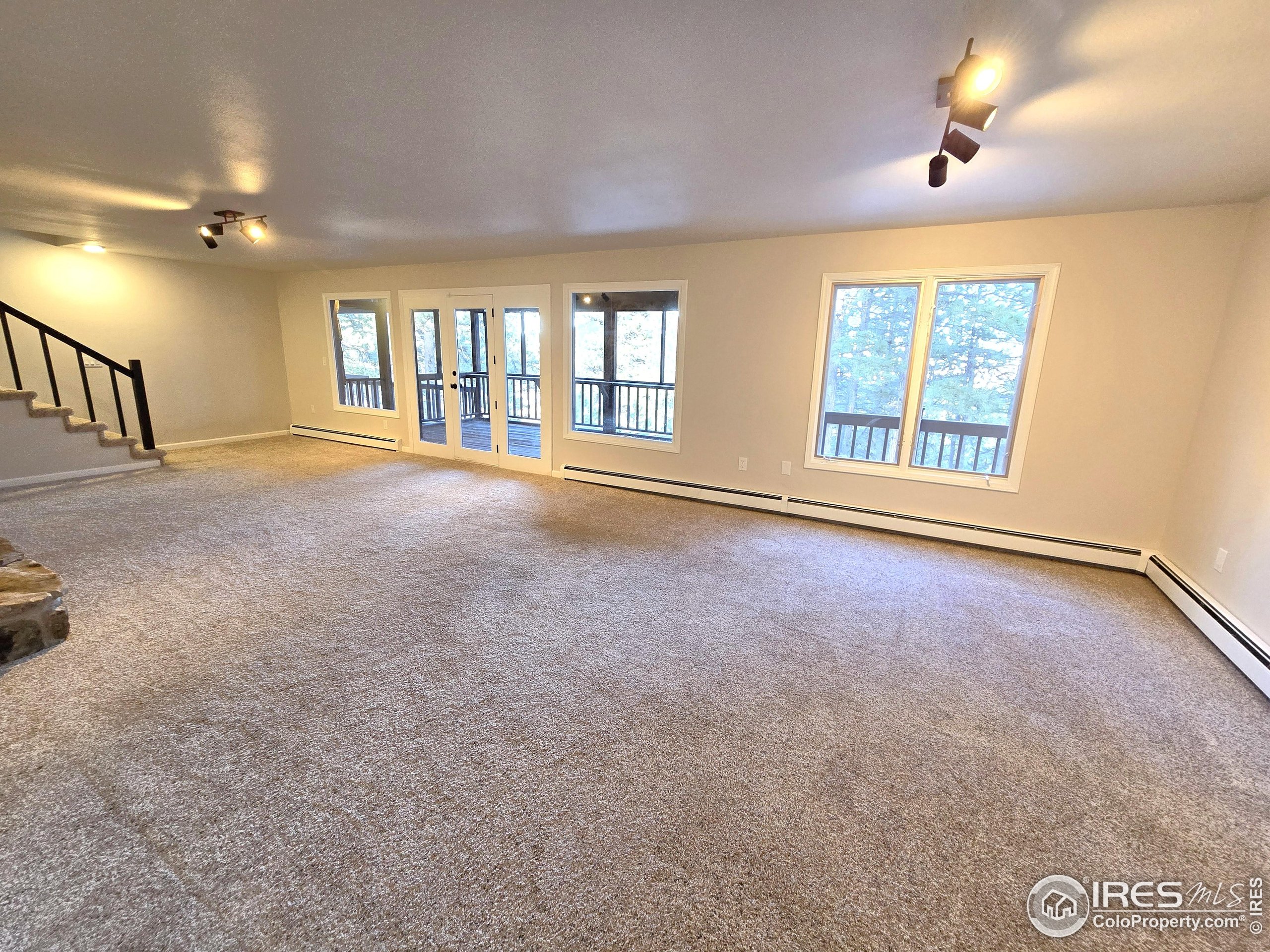 76 Pine Tree Lane Boulder, CO 80304 - Photo 25 of 49 an empty room with windows and ceiling fan
