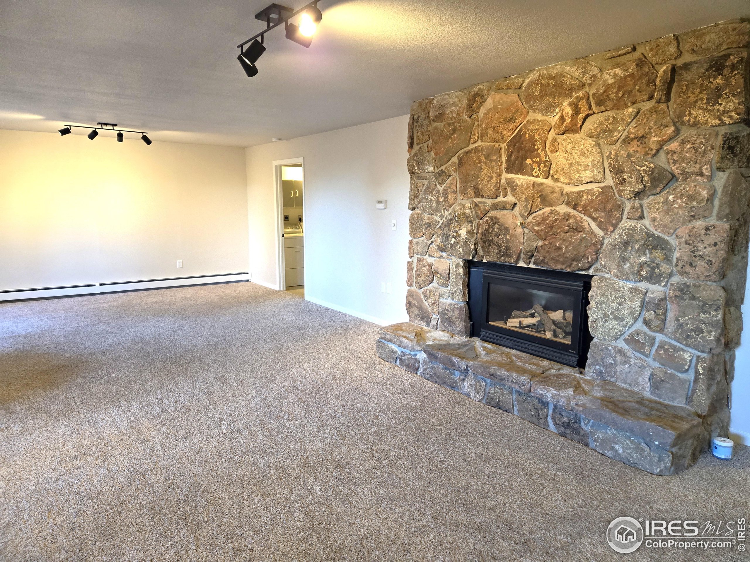 76 Pine Tree Lane Boulder, CO 80304 - Photo 29 of 49 a view of empty room with a fireplace