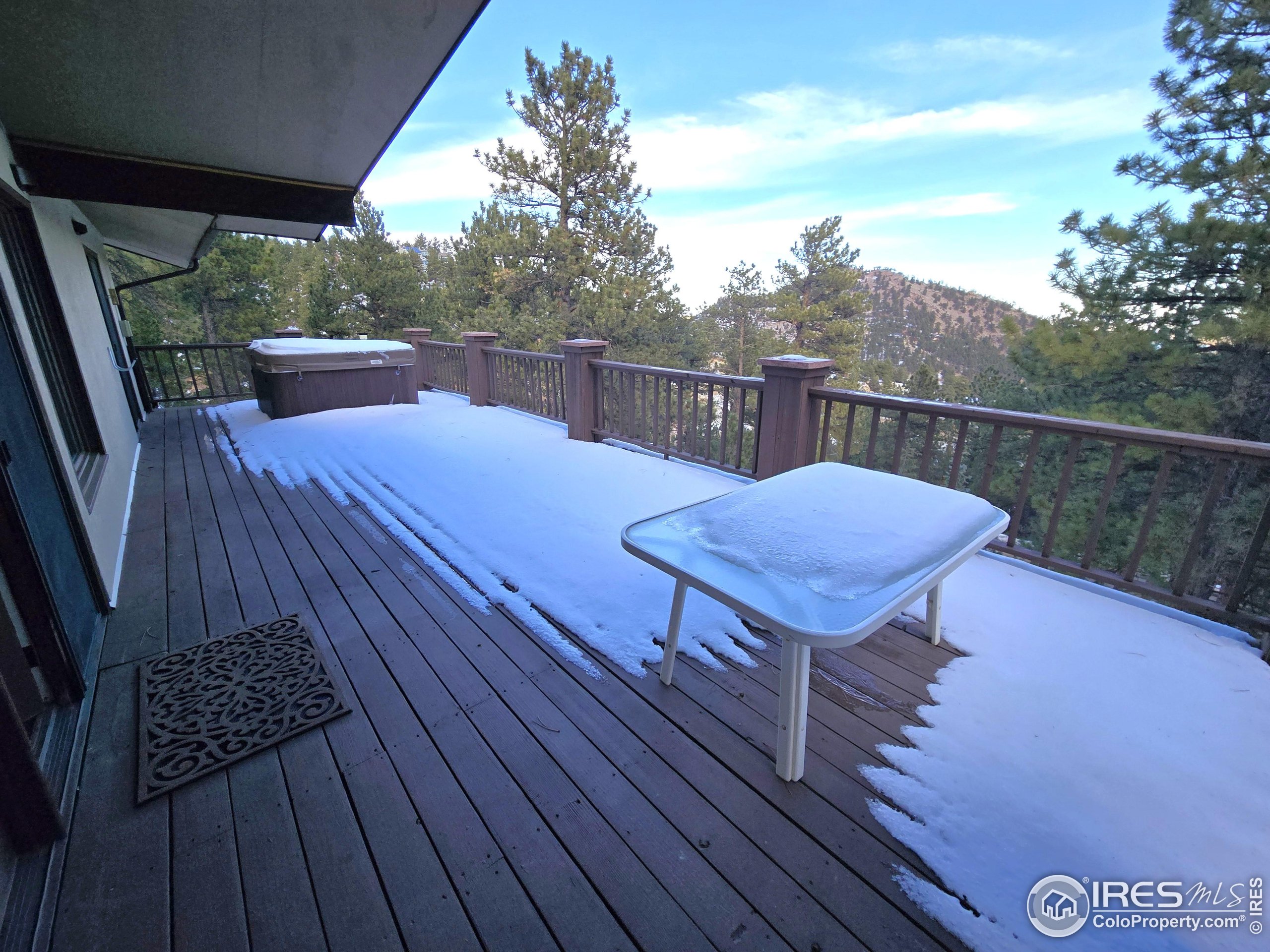 76 Pine Tree Lane Boulder, CO 80304 - Photo 33 of 49 a view of a deck with wooden floor and seating space
