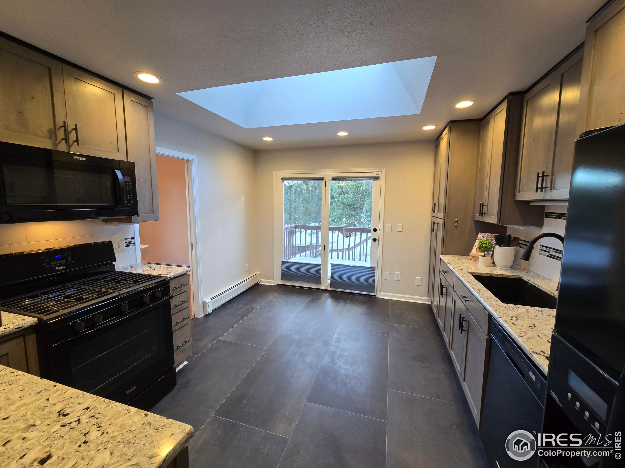 76 Pine Tree Lane Boulder, CO 80304 - Photo 9 of 49 a kitchen with granite countertop a stove and a sink