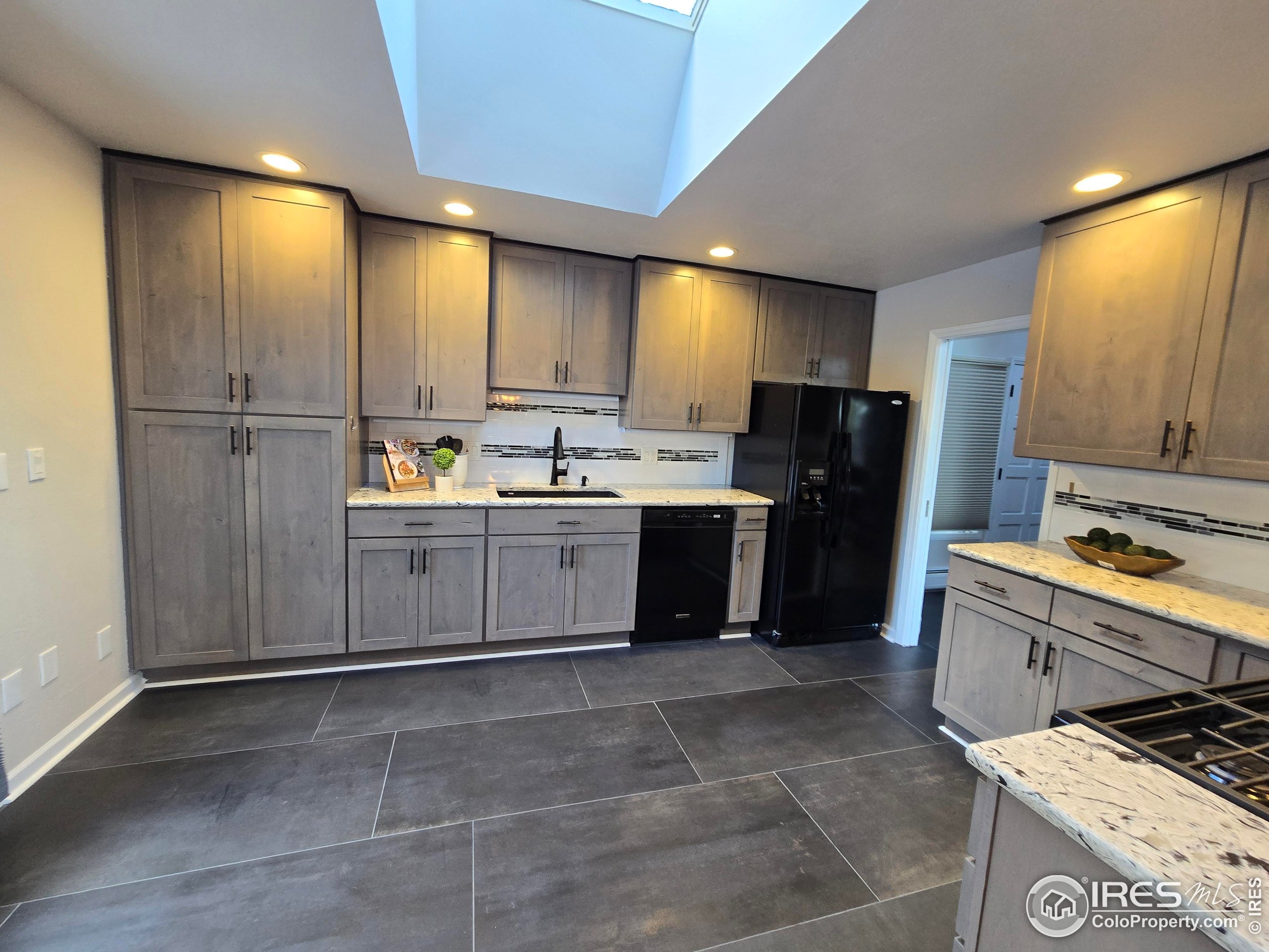 76 Pine Tree Lane Boulder, CO 80304 - Photo 10 of 49 a kitchen with a sink a refrigerator and cabinets