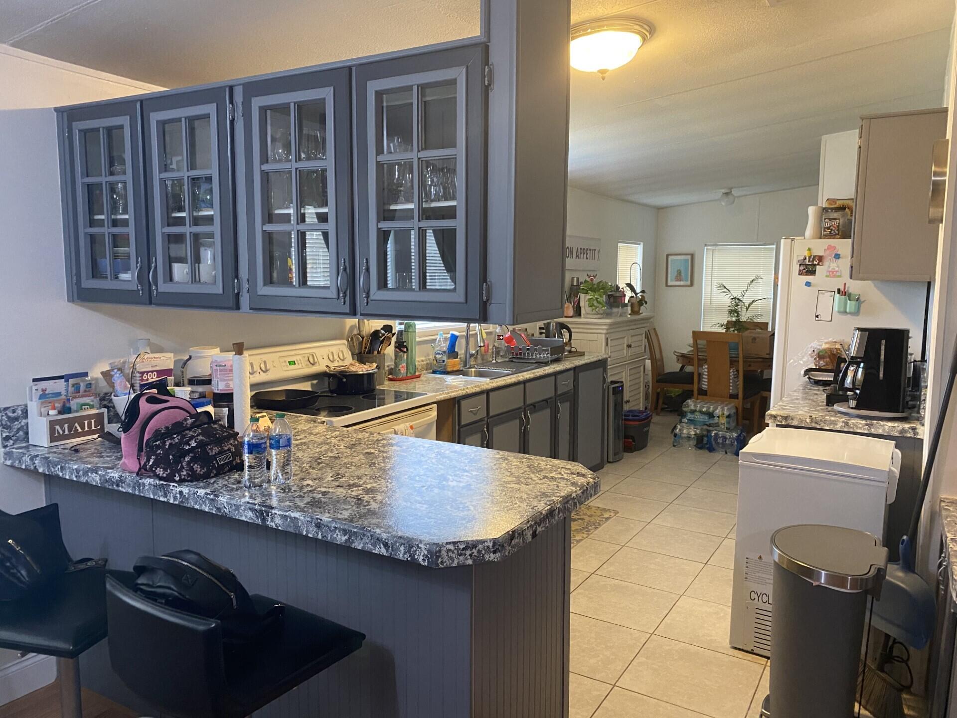 1531 Drexel Road West Palm Beach, FL 33417 - Photo 12 of 35 a kitchen with a stove and a refrigerator