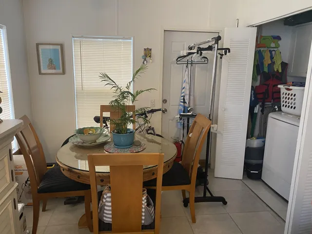 a view of a dining room with furniture and a chandelier
