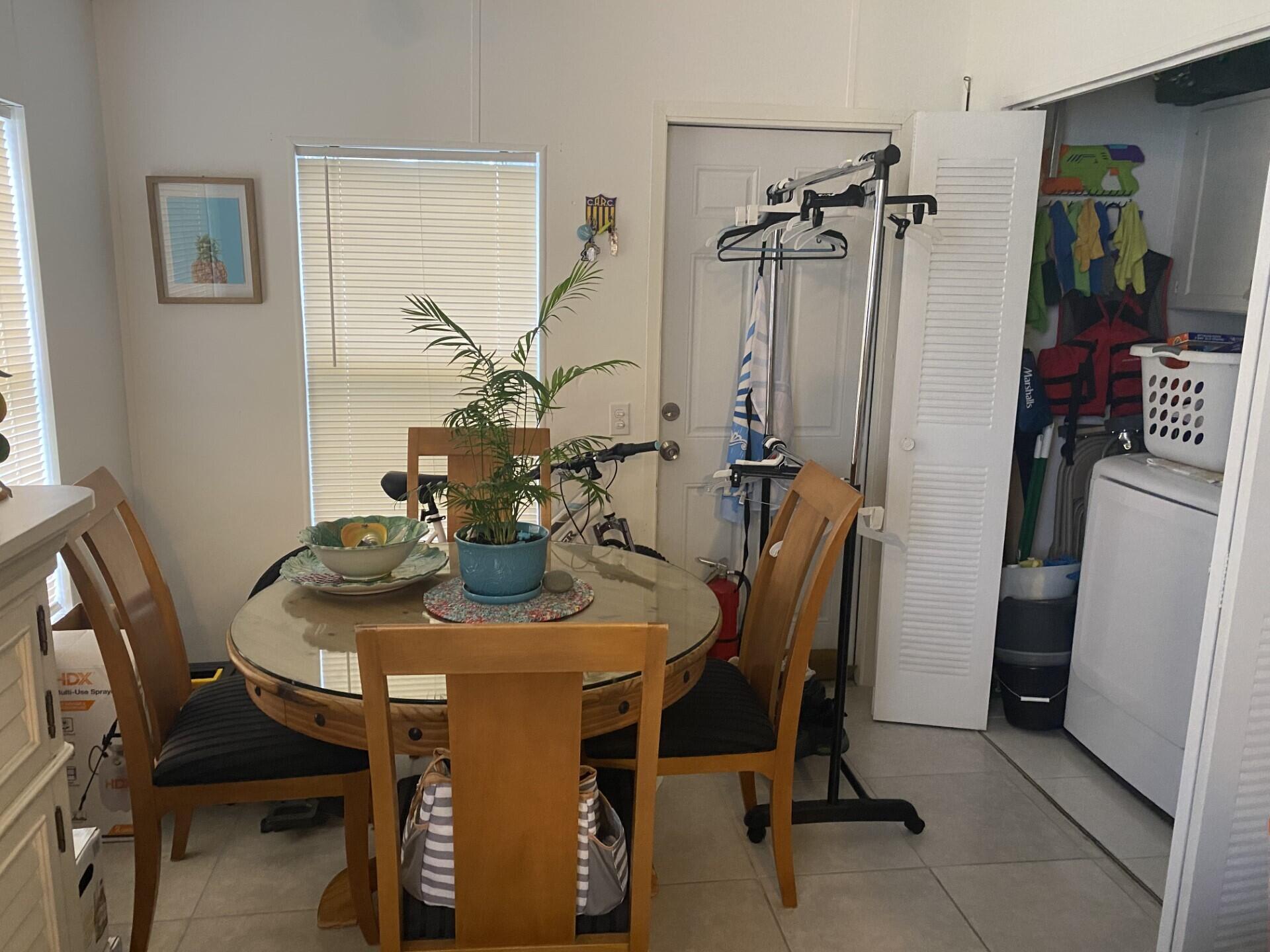 1531 Drexel Road West Palm Beach, FL 33417 - Photo 15 of 35 a view of a dining room with furniture and a chandelier