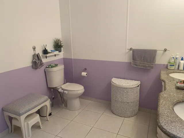 a bathroom with a toilet a sink and a mirror
