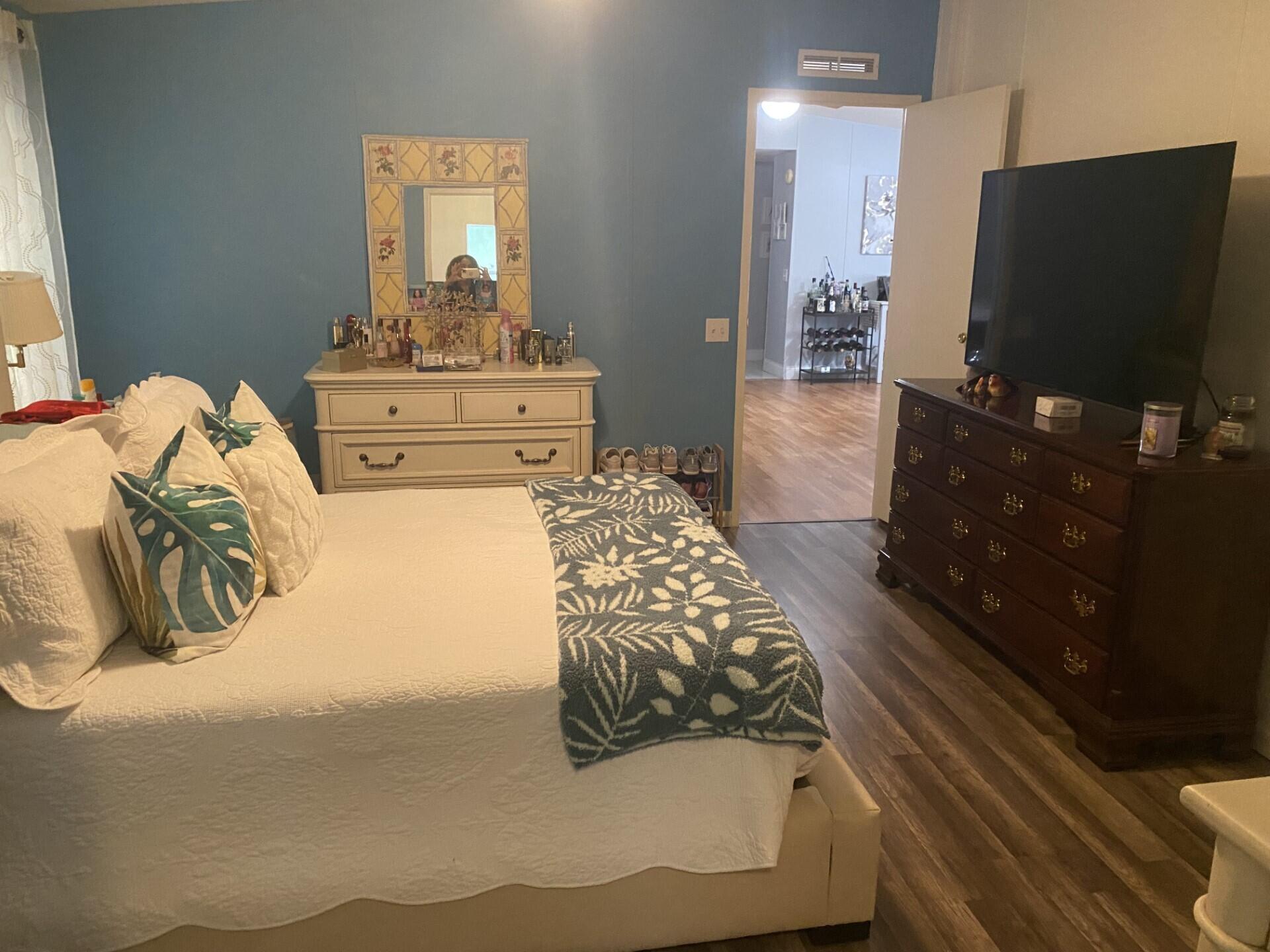 1531 Drexel Road West Palm Beach, FL 33417 - Photo 22 of 35 a bedroom with a bed and mirror