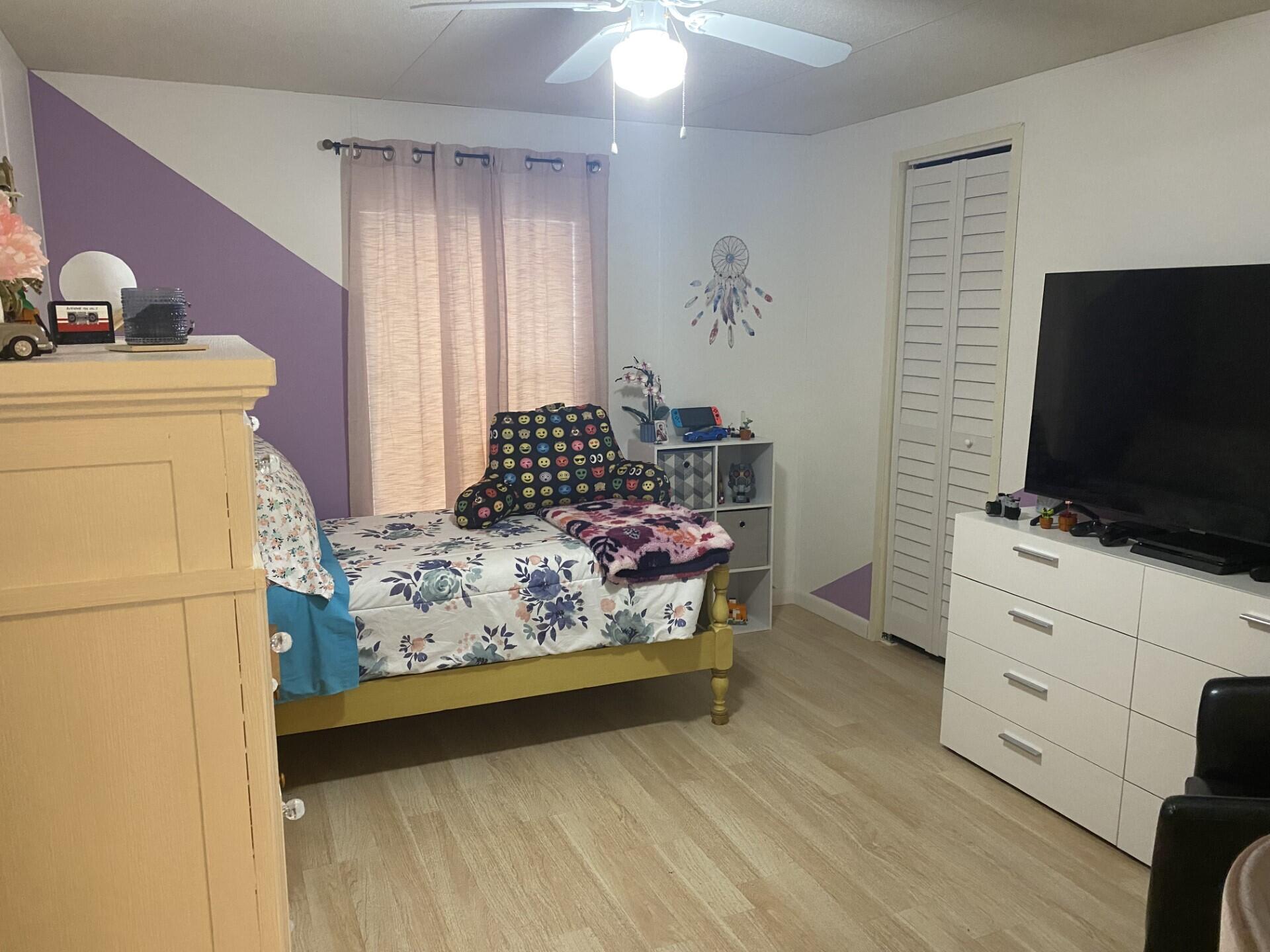 1531 Drexel Road West Palm Beach, FL 33417 - Photo 23 of 35 a bedroom with a bed and flat screen tv