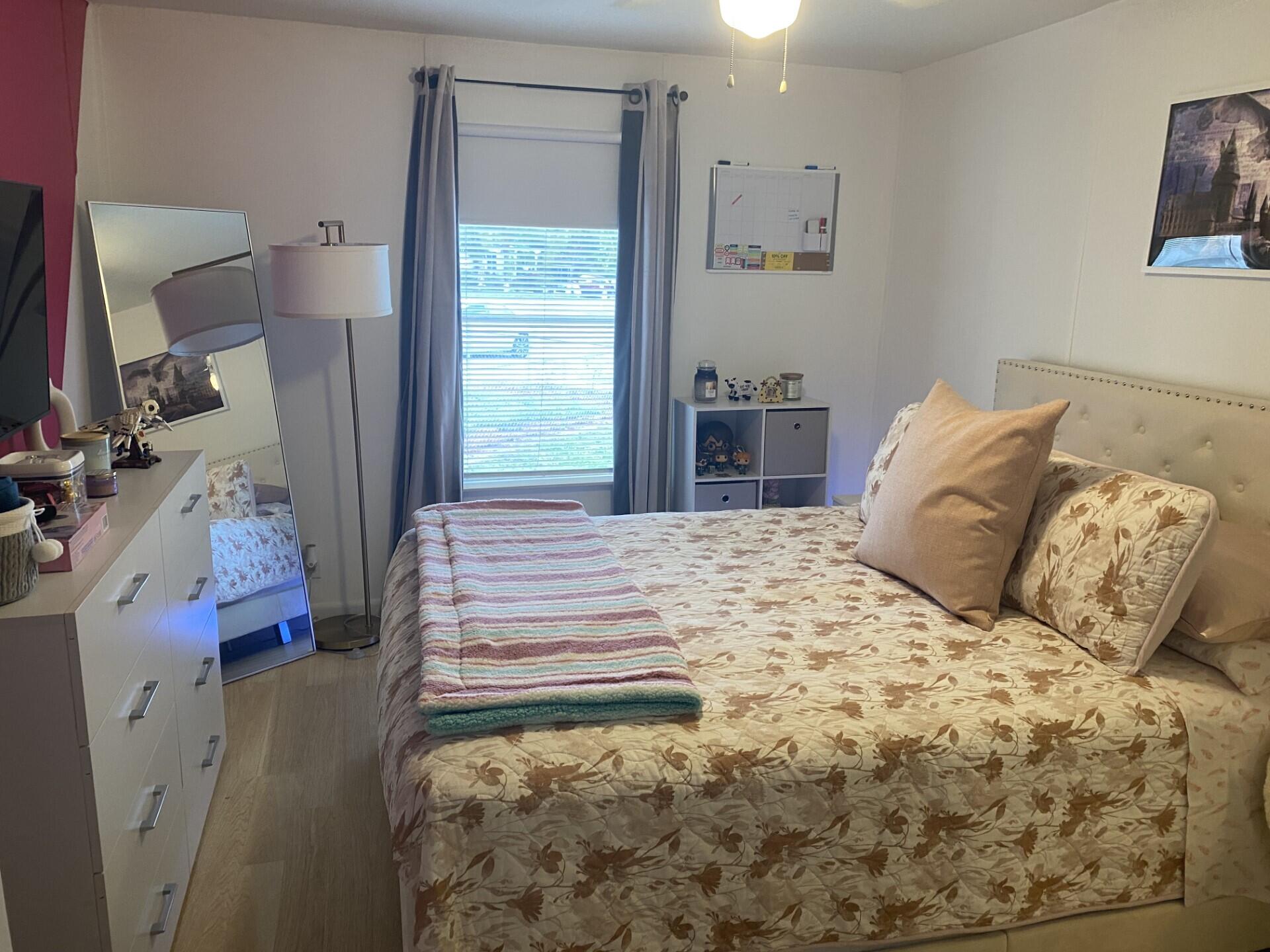 1531 Drexel Road West Palm Beach, FL 33417 - Photo 26 of 35 a bedroom with a bed and a large mirror