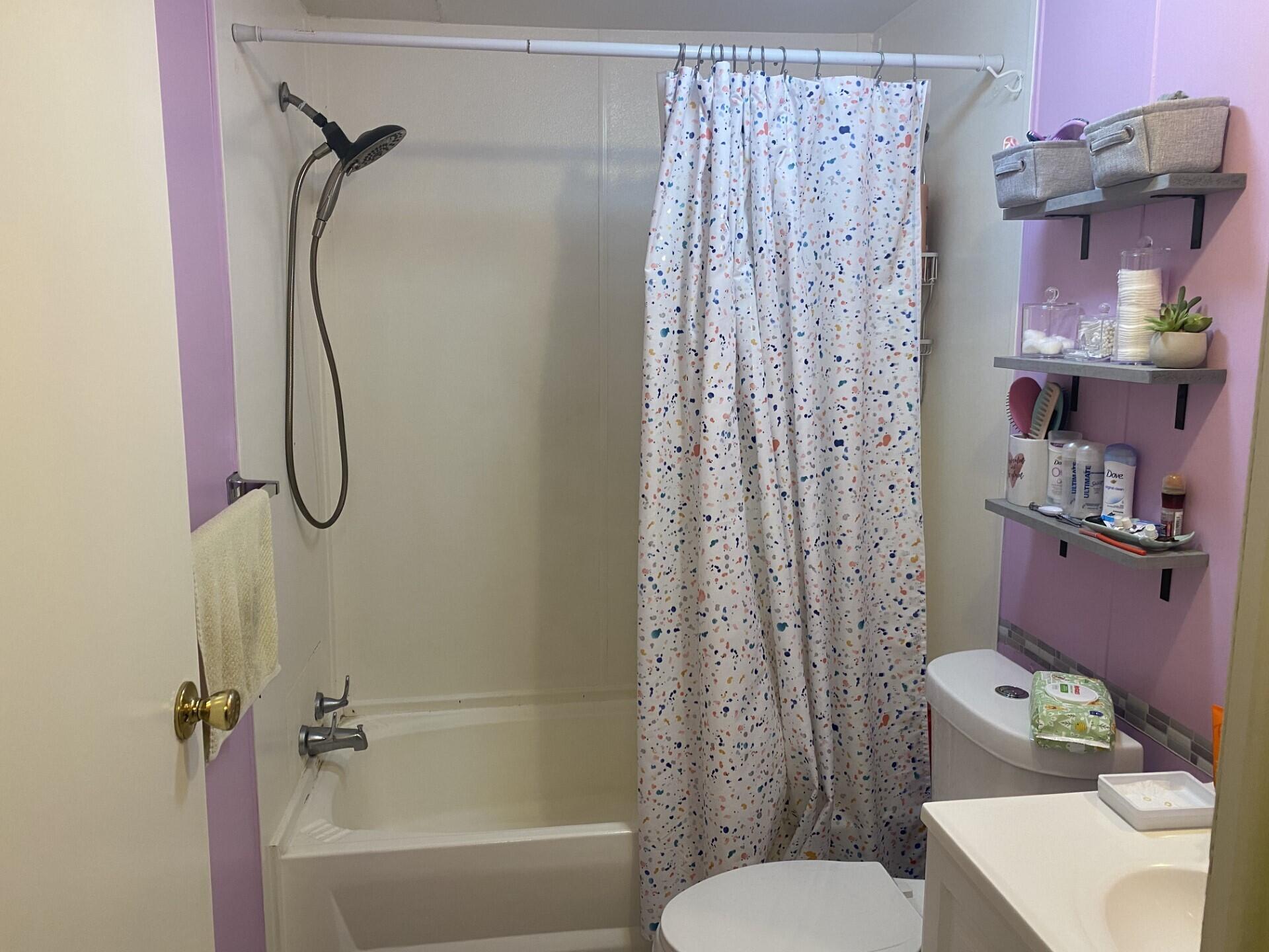 1531 Drexel Road West Palm Beach, FL 33417 - Photo 29 of 35 a bathroom with a bath tub shower and a toilet sink