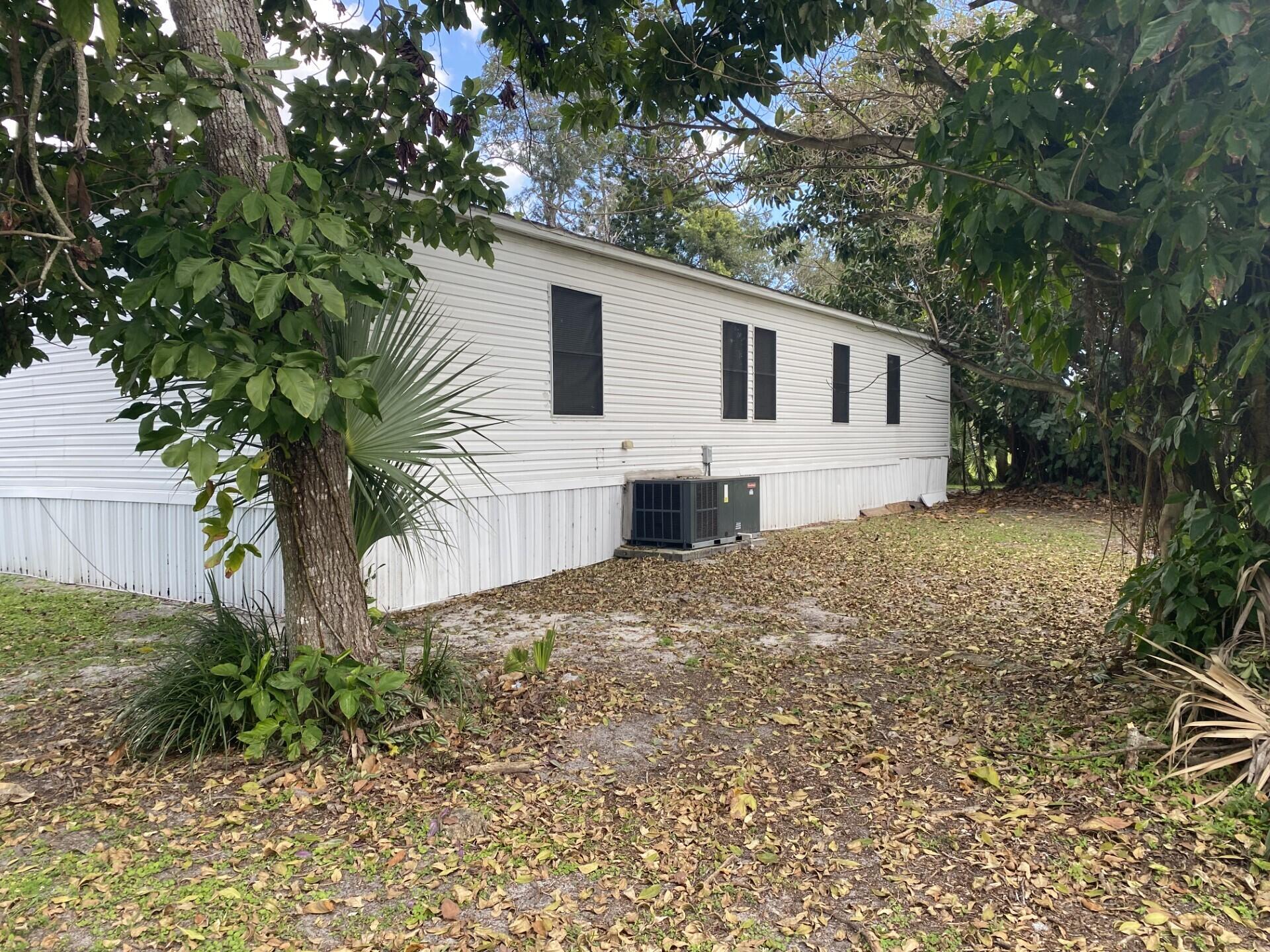 1531 Drexel Road West Palm Beach, FL 33417 - Photo 30 of 35 a house with a yard and a large tree