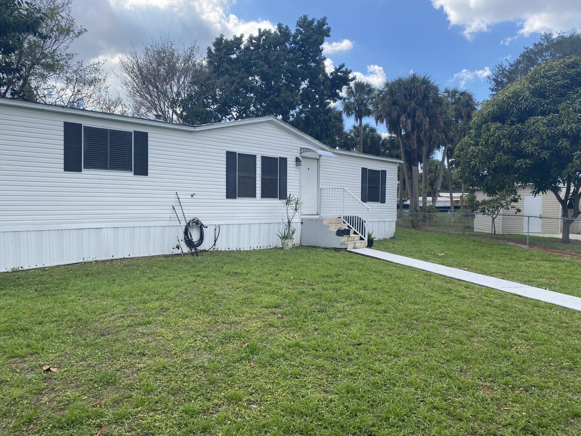 1531 Drexel Road West Palm Beach, FL 33417 - Photo 3 of 35 a front view of house with yard and green space