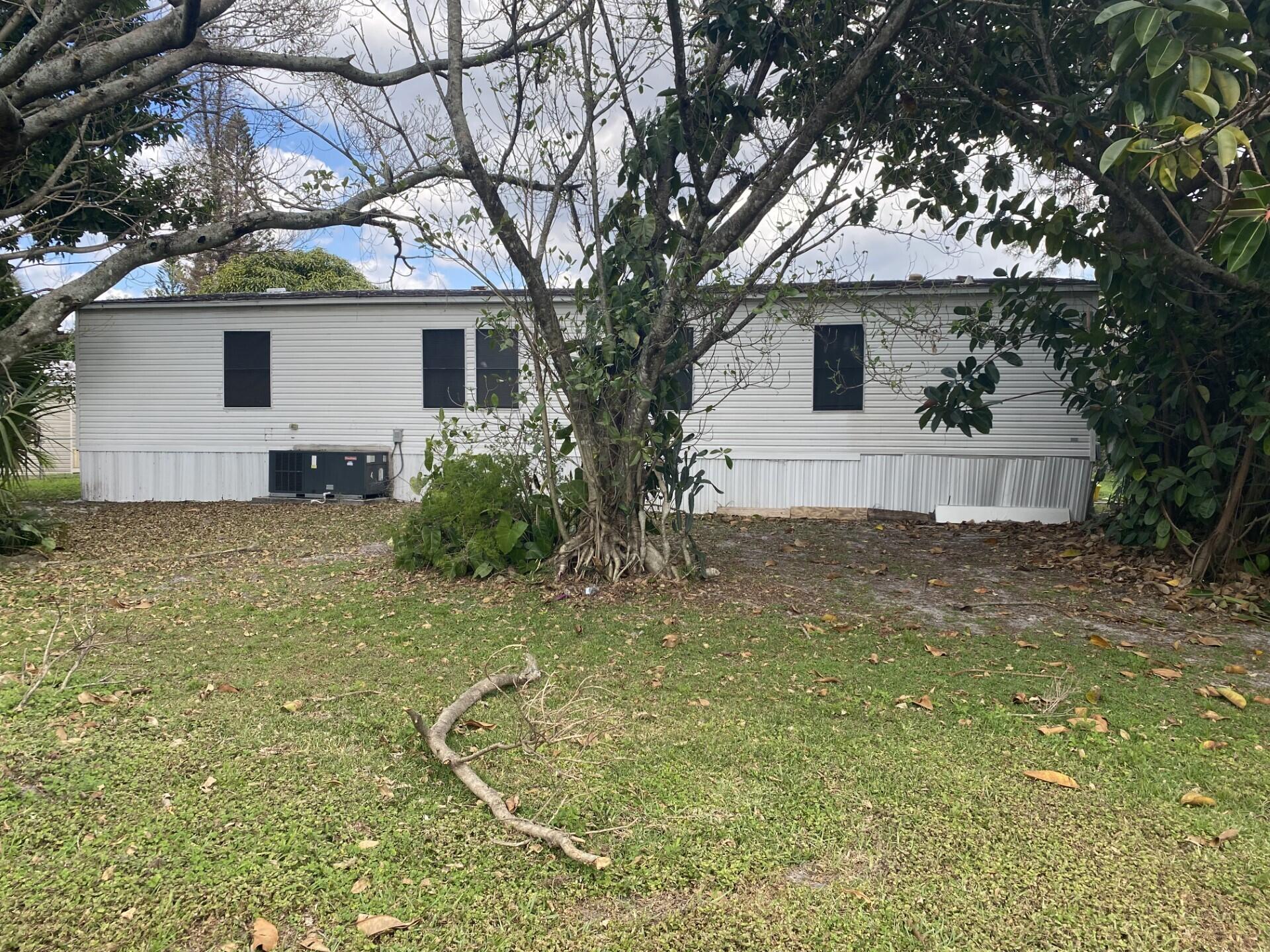1531 Drexel Road West Palm Beach, FL 33417 - Photo 31 of 35 a view of a house with a backyard and a tree