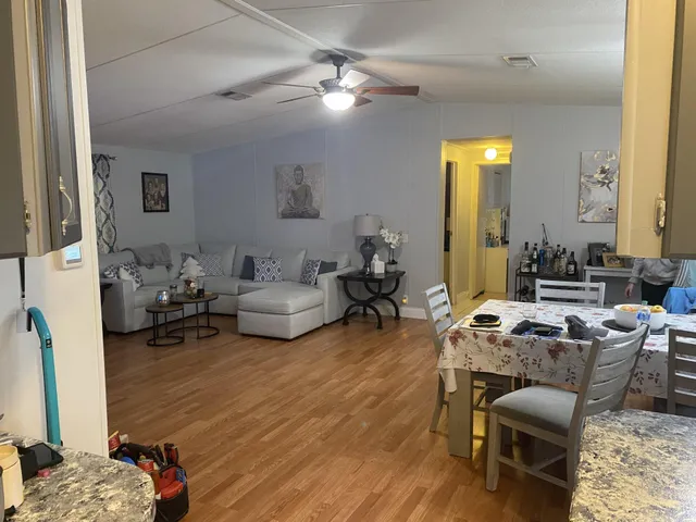a living room with furniture a fireplace and a chandelier