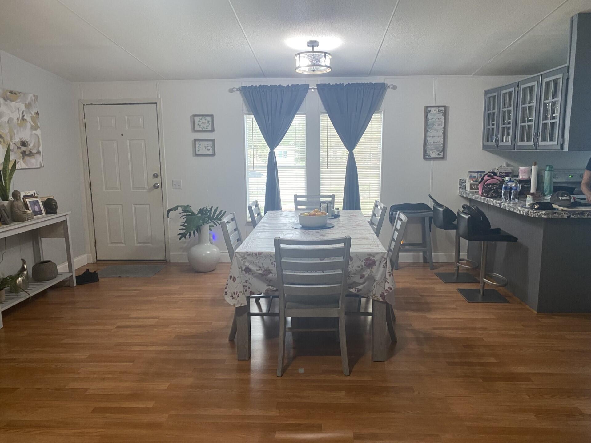 1531 Drexel Road West Palm Beach, FL 33417 - Photo 9 of 35 a view of a dining room with furniture and wooden floor