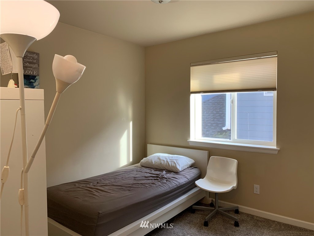3627 Northeast 6th Street Renton, WA 98056 - Photo 24 of 40 a bedroom with a bed and a dresser next to a window