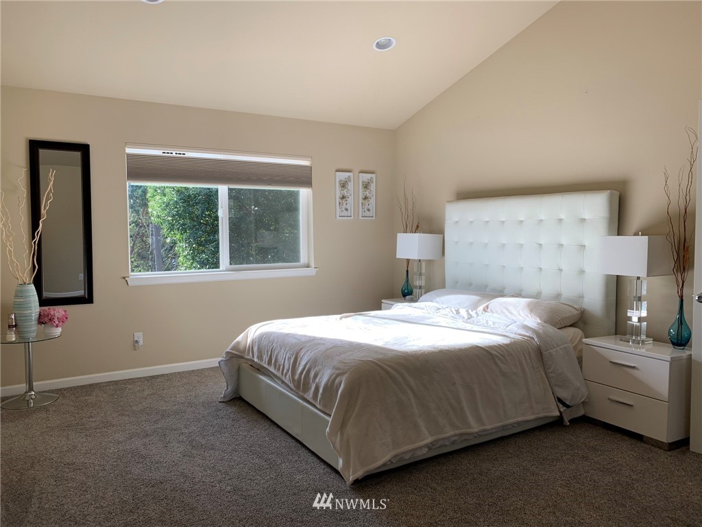 3627 Northeast 6th Street Renton, WA 98056 - Photo 31 of 40 a bedroom with a bed lamp and window