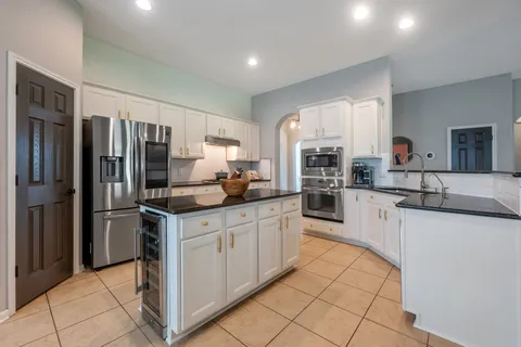 a kitchen with stainless steel appliances granite countertop a refrigerator sink and cabinets