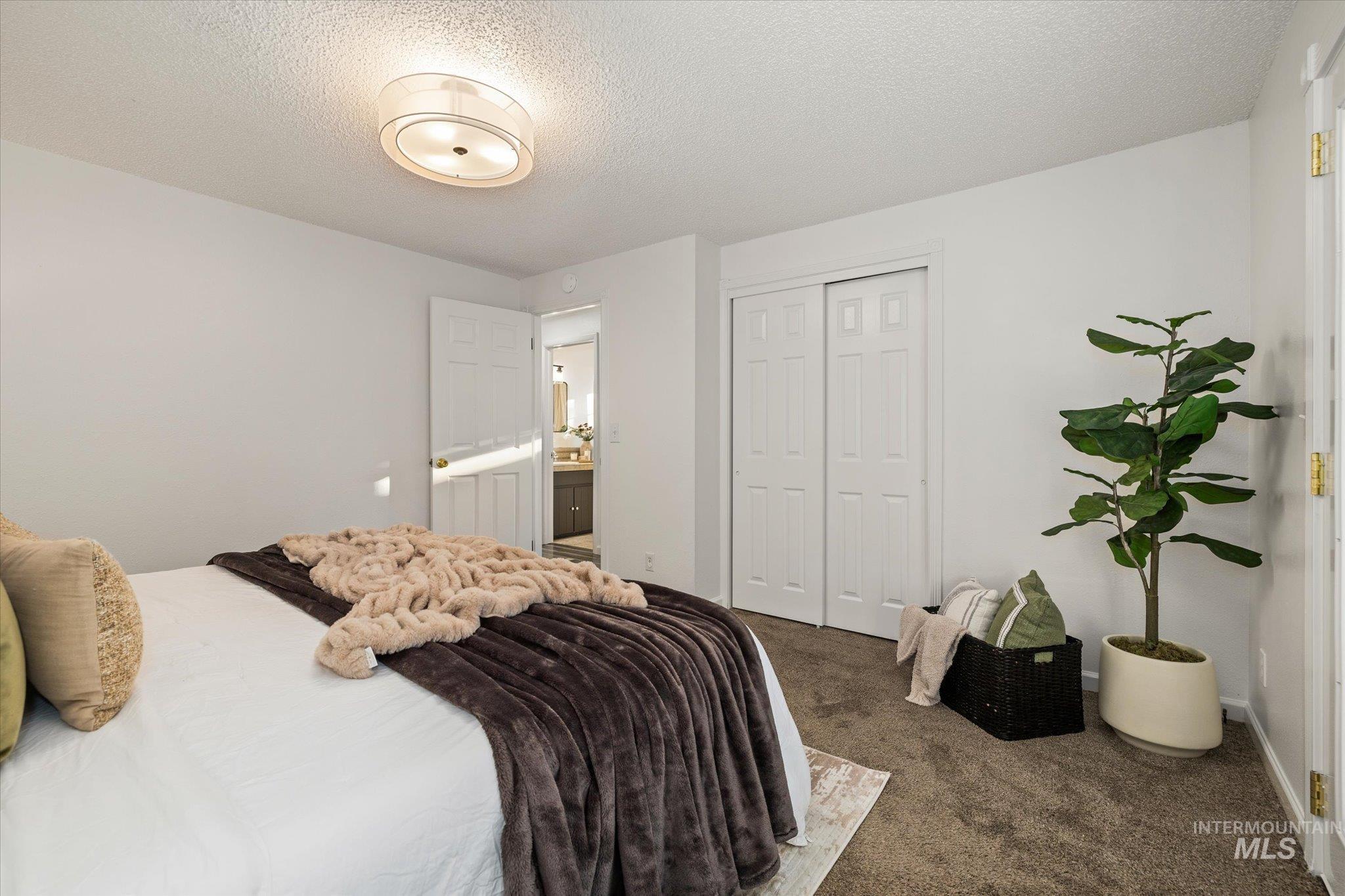 2302 Pendleton Street Boise, ID 83705 - Photo 21 of 35 Carpeted bedroom featuring a flush mount ceiling light, white paneled doors, and a double-door closet