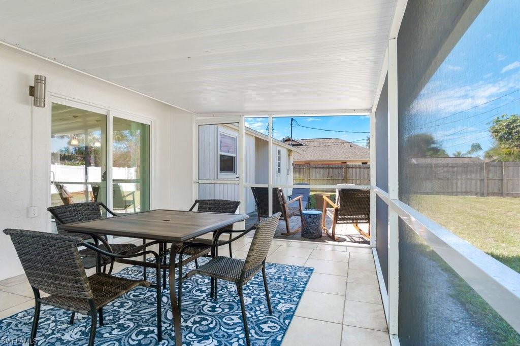1207 Hernando Street Naples, FL 34103 - Photo 15 of 37 a dining room with furniture and a large window