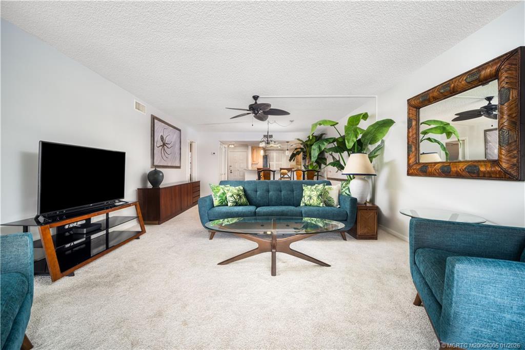 3100 Southeast Pruitt Road, Unit G205 Port St. Lucie, FL 34952 - Photo 12 of 29 a living room with furniture and a flat screen tv