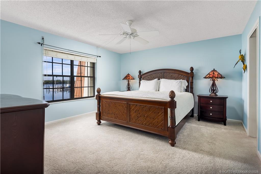 3100 Southeast Pruitt Road, Unit G205 Port St. Lucie, FL 34952 - Photo 15 of 29 a bed room with a bed and a window